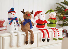 Load image into Gallery viewer, 4 hand knitted shelf sitters on top of drawers. All have long legs dangling over the edge. The snowman has a stripy scarf and pom pom hat, rudolph is wearing a blue scarf, Father Christmas and an elf with red and white striped legs finish the group
