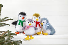 Load image into Gallery viewer, 4 tinsel penguins. All have white faces and fronts. Head top, back and wings are black, purple, gold or blue tinsel. The black penguin has an orange beak and feet, the others are yellow DK yarn. Red, blue, pink and green scarves in seed stitch