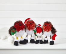 Load image into Gallery viewer, A row of 4 robins. 3 knitted in tinsel yarn - brown and white with a red breast. 1 has a green dk yarn gift with red bow and 1 has a red and white stocking. All wear black boots with white trim. A small robin knitted in DK yarn has a green cracker
