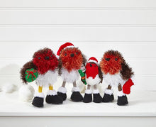 Load image into Gallery viewer, A row of 4 robins. 3 knitted in tinsel yarn - brown and white with a red breast. 1 has a green dk yarn gift with red bow and 1 has a red and white stocking. All wear black boots with white trim. A small robin knitted in DK yarn has a green cracker