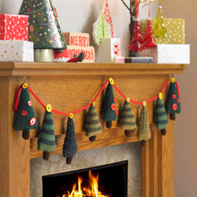 Load image into Gallery viewer, Festive mantlepiece with Christmas tree knitted bunting. Trees are attached to a red knitted cord with yellow buttons. There are 4 Xmas tree designs - dark green with red buttons, dark and light green stripes, dark and olive green stripes, dark green