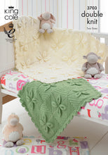 Load image into Gallery viewer, Image of the cover of King Cole knitting pattern 3703. The image shows a large cream and smaller green blanket draped over a baby cot with soft toy decor. The blanket is knitted in squares that create a leaf design and striped diamonds