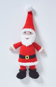 Santa or Father Christmas knitted toy. He has black boots with roll tops, red trousers and a long red jumper trimmed with white fur and a large black belt with gold buckle. He has a fluffy white beard and a red fur trimmed hat with white pompom