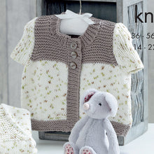 Load image into Gallery viewer, Close up of short sleeve cardigan. The tops of the fronts and the bands are knitted in light brown cotton DK yarn. The main sections of the fronts and the sleeves are knitted in a cream cotton yarn with brown and green flecks
