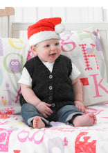 Load image into Gallery viewer, Baby sitting on a bed and wearing a hand knitted Santa hat. The yarn has a furry texture and the main section is knitted in red with a white brim and matching white pom pom