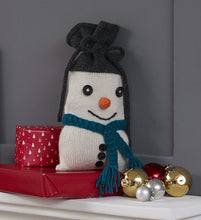 Load image into Gallery viewer, Fun snowman gift back. His hat is black with a drawstring to close the bag. Knitted in white with an orange nose, teal scarf, black embroidered mouth and finished with black buttons for the eyes and down the front