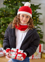 Load image into Gallery viewer, A young girl wearing a white tshirt and black jacket in front of an Xmas tree holding a gift. She is wearing a red beanie hat with white turnback and pompom. Her snood is red with two white rib bands and her fingerless gloves are red with white bands