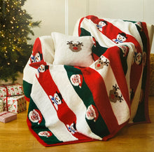 Load image into Gallery viewer, Festive blanket or throw and cream cushion with a reindeer motif in light brown with dark brown antlers and red nose. The reindeer repeats on the white stripe of the blanket. The other stripes are red and green with santa, a snowman, or plain stripe