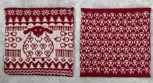 Load image into Gallery viewer, This amazing cushion is knitted in red and white yarn. The front has a sheep in the middle and the rest is made up of mini sheep, tree and snowflake motifs. The back is rows of outlines of sheep. It is classy and fun and will make a perfect gift