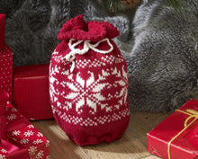 Load image into Gallery viewer, A red gift bag with white drawstring. The body of the bag has rows of contrasting white stitches in snowflake motifs. The picot edging at the top gives a lovely finish
