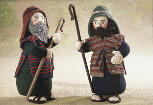 Image of two knitted shepherds from the Alan Dart Nativity knitting pattern. Each shepherd is knitted in different colours making them unique and distinct characters. Their beards are different textures and they are each carrying a staff