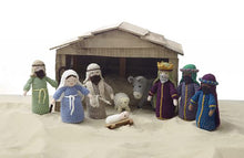 Load image into Gallery viewer, A crocheted nativity set picture on sand in front of a wooden stable. Joseph, Mary, babyJesus, donkey, sheep, shepherd and the 3 wise men. All wear robes and head dresses. One wise man has a crown and all the men have beards