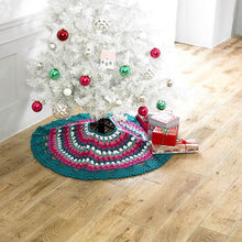 Load image into Gallery viewer, Stunning crocheted Christmas tree skirt. Circular festive skirt crocheted with a deeper outer band in teal, then stripes of purple, red, pink, lighter green and white. The inner hem is finished in teal