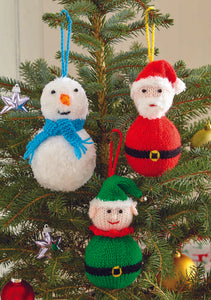 Image of a Christmas tree with 3 hand knitted character baubles. A large ball (body) with a small ball (head). The snowman is knitted in white fur effect wool with a blue scarf. The elf is green and santa is red - they have a fur trimmed hat 