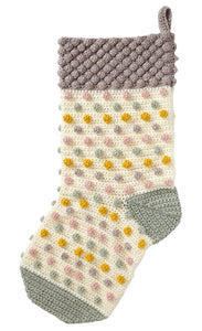 Image of a crocheted stocking. The heel and toe are crocheted in grey and the main leg in cream. The main section has rows of bobbles in pale pink, grey and green with antique gold. The top is covered in bobbles and crocheted in grey or silver yarn