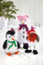 Load image into Gallery viewer, All three toy designs - tinsel penguin with DK yarn green scarf, orange beak and feet. White snowman with black boots, red pom pom scarf and DK yarn tea bag hat. The robin has black boots with white fur trim, stick legs and a traditional Santa hat
