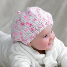 Load image into Gallery viewer, Image of a baby wearing a cute beret. The edge is a short rib and the main beret is knitted using stocking stitch. The image show a white yarn with different shades of pink as flecks
