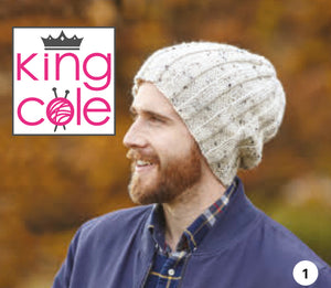Image of a man wearing a slouchy rib beanie hat. The hat is hand knitted in a cream Aran yarn with dark flecks
