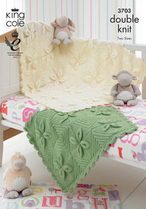 Image of the cover of King Cole knitting pattern 3703. The image shows a large cream and smaller green blanket draped over a baby cot with soft toy decor. The blanket is knitted in squares that create a leaf design and striped diamonds