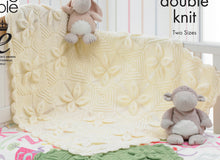 Load image into Gallery viewer, Close up of cream cot baby blanket in green yarn. Knitted in squares with four leaf motifs meeting at a corner. The rest of the square is knitted in a diagonal - half garter stitch and half stocking and garter stitch. Finished with a leaf border
