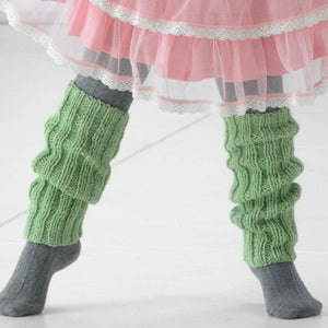 Image of close up of dance leg warmers hand knitted in green yarn. They are knitted using a wide rib stitch and are worn slouched over grey wool tights