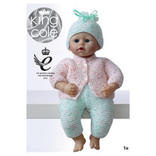 Load image into Gallery viewer, Image of 40cm toy doll wearing pale green trousers and matching hat with pale pink cardigan knitted in garter stitch. The yarn has subtle, slightly darker flecks through it

