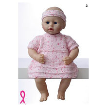 Load image into Gallery viewer, Image of a 40cm 16inch toy doll wearing a pink dress with multi shades of pink flecks. The dress has short sleeves and is knitted in stocking stitch. Occasional rows of garter stitch add textured stripes. She wears a matching headband
