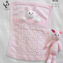 Load image into Gallery viewer, Close up of pale pink baby blanket with garter stitch border, square textured main design. The blanket has the head and front paws of a rabbit attached to look like it is in bed. Garter stitch rabbit toy also shown. Knitted in DK baby yarn
