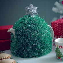 Load image into Gallery viewer, A festive Christmas tree tea cosy knitted in emerald green mixed with silve tinsel yarn and topped with a silver star knitted in DK yarn. 
