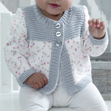 Load image into Gallery viewer, Image of a close up of the long sleeve cardigan. Cuffs and bands are knitted in silver cotton yarn. Sleeves and main sections of the fronts are knitted in white yarn with pink and silver flecks. Top of the fronts is knitted in silver garter stitch
