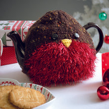 Load image into Gallery viewer, A robin red breast tea cosy. The main body is knitted in a dark brown yarn with colourful flecks. The breast is knitted in a rich red tinsel. A yellow beak and black eyes are added to complete the festive bird
