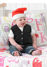 Load image into Gallery viewer, Baby sitting on a bed and wearing a hand knitted Santa hat. The yarn has a furry texture and the main section is knitted in red with a white brim and matching white pom pom 
