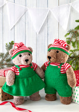 Load image into Gallery viewer, A couple of elf toy bears. Both have red and white striped short sleeve tops and matching striped hat. The had has a green band and is topped with a gold bell. They both wear bib outfits - a pinafore and dungarees in green yarn with red buttons
