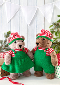 A couple of elf toy bears. Both have red and white striped short sleeve tops and matching striped hat. The had has a green band and is topped with a gold bell. They both wear bib outfits - a pinafore and dungarees in green yarn with red buttons