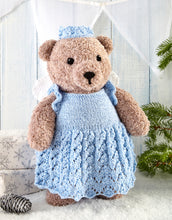 Load image into Gallery viewer, Light brown traditional teddy knitted in fake fur yarn. The bear wears a Christmas fairy outfit in pale blue. The dress has ruffle capped sleeves and the skirt of the dress is knitted in cable and lace stitches. White wings and a light blue crown 
