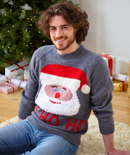 Load image into Gallery viewer, Man wearing a fun, hand knitted sweater in grey yarn with a large Santa face on the front. Under the face are the letters Ho Ho Ho. Santa has a fury beard, red mouth and nose, blue eyes and is wearing a red hat with white band and pompom
