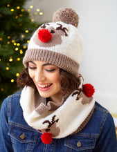Load image into Gallery viewer, Woman wearing a denim jacket with reindeer beanie hat and snood. The reindeer motifs on the hat and snood are light brown with dark brown antlers and eyes and red pompom nose. The main sections are cream and the bands and pompom are light brown
