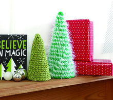 Load image into Gallery viewer, Simple but effective crocheted Xmas tree decorations or ornaments. Two sizes, the crocheted pieces cover a polystyrene cone. The small one is crocheted in green and the larger one is a green yarn mixed with white tinsel for a snowy finish
