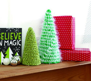 Simple but effective crocheted Xmas tree decorations or ornaments. Two sizes, the crocheted pieces cover a polystyrene cone. The small one is crocheted in green and the larger one is a green yarn mixed with white tinsel for a snowy finish