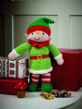 Load image into Gallery viewer, Crocheted elf toy. Emerald green boots, red and white striped leggings and an emerald green hat with red band and topped with a bell. His multi-pointed neckband is red to match his belt. His bright green tunic is fur trimmed in white
