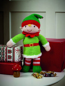 Crocheted elf toy. Emerald green boots, red and white striped leggings and an emerald green hat with red band and topped with a bell. His multi-pointed neckband is red to match his belt. His bright green tunic is fur trimmed in white