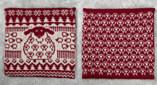 Load image into Gallery viewer, This amazing cushion is knitted in red and white yarn. The front has a sheep in the middle and the rest is made up of mini sheep, tree and snowflake motifs. The back is rows of outlines of sheep. It is classy and fun and will make a perfect gift

