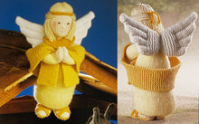 Load image into Gallery viewer, Image of knitted Angel from the Alan Dart Nativity knitting pattern. The front and the back of the angel are shown. She is dressed in different shades of yellow and gold and her wings are white
