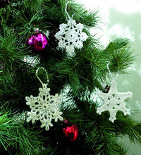 Load image into Gallery viewer, 3 crocheted Christmas snowflake tree ornaments. All have white hanging loops and have different lace effect, star shaped designs
