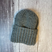 Load image into Gallery viewer, Hand knitted grey aran beanie with deep rib turnback. The main section of the hat is knitted in fisherman&#39;s rib for a thick, chunky rib effect. Knitted using King Cole pattern 3461 and graphite Fashion Aran yarn
